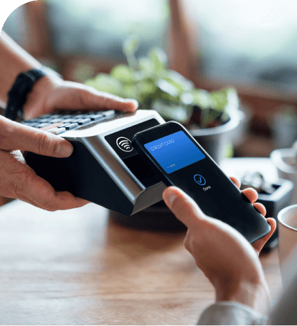 Close up of hands completiong a purchase with a IC card to a terminal